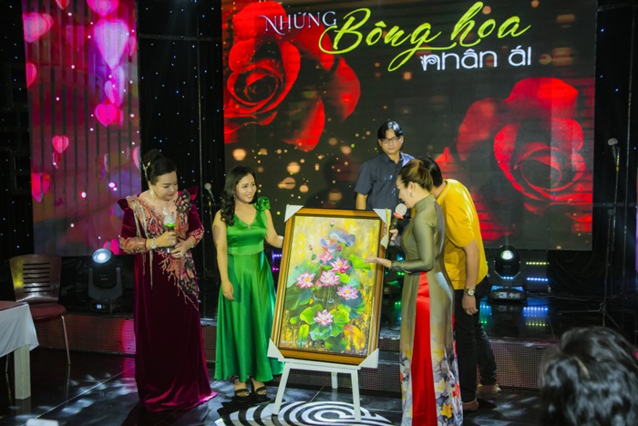 Họa sĩ Lê Quế Anh (thứ 2 từ trái sang) giới thiệu tác phẩm đấu giá trong chương trình "Những bông hoa Nhân ái" tối 20/10